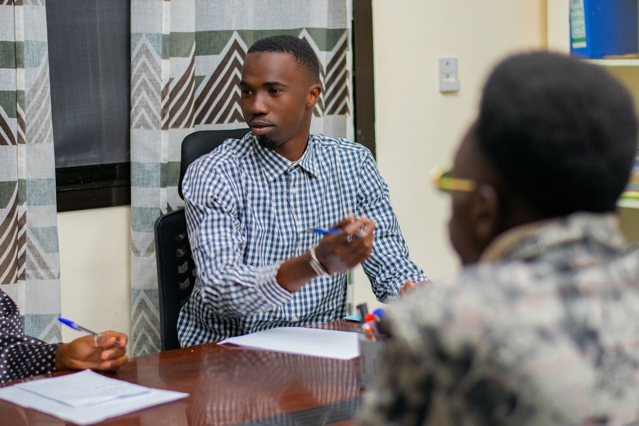 Business professionals engaged in a focused meeting around a conference table.