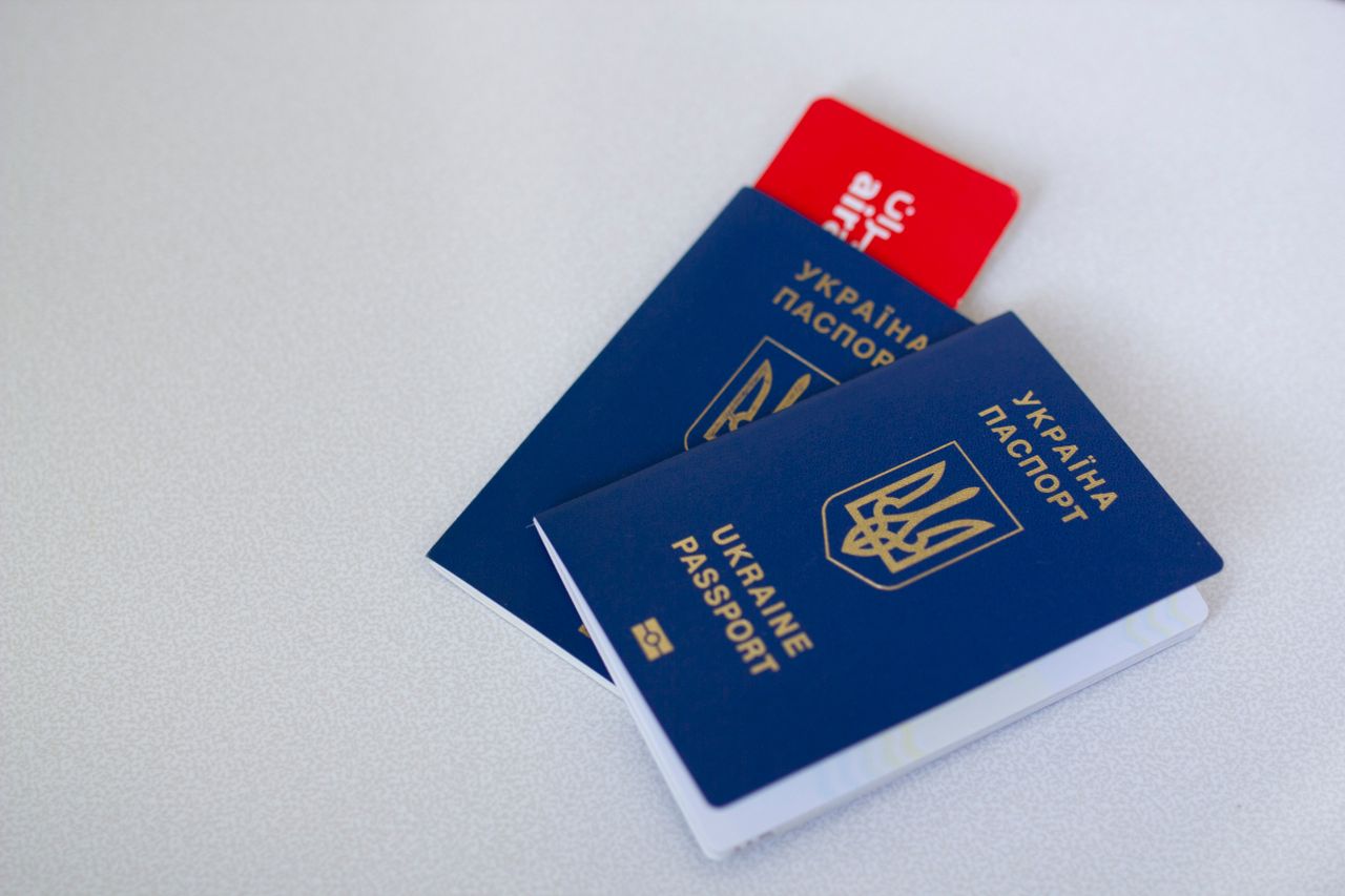 why-choose-us Close-up of Ukrainian passports and travel card on a light surface with ample copy space.